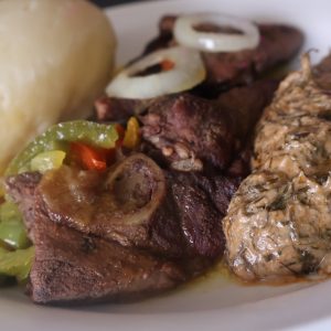 Chevre Fumbwa Fufu | Authentic Congolese goat with cassava leaves and fufu at Ma Yve Grill
