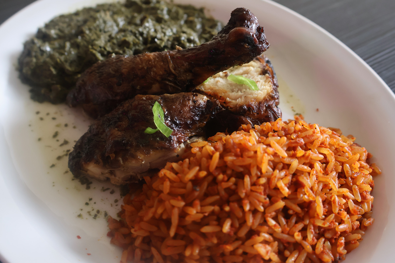 Jollof Chicken Pondu | Authentic tomato rice with charcoal-grilled chicken and cassava leaves at Ma Yve Grill